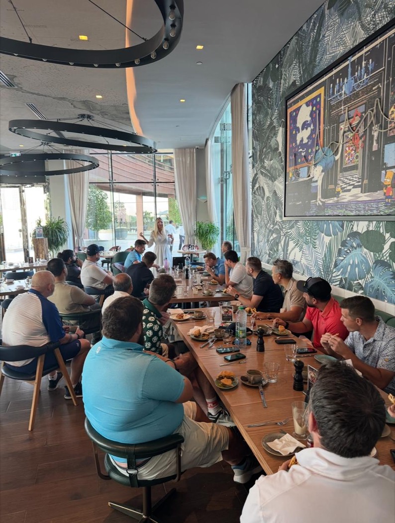Members around long tables at a networking breakfast