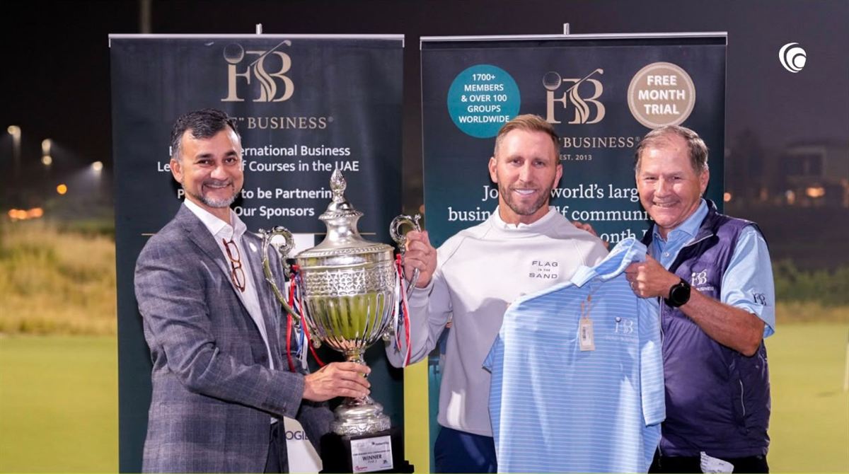 Presenting the winner a trophy and a prize at an evening event